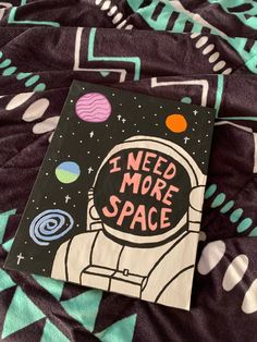 i need more space book sitting on top of a bed