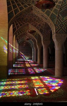 the sun shines through stained glass windows in an ornate building