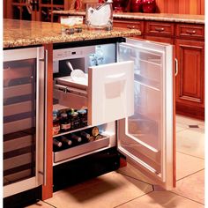 an open refrigerator in a kitchen next to a counter