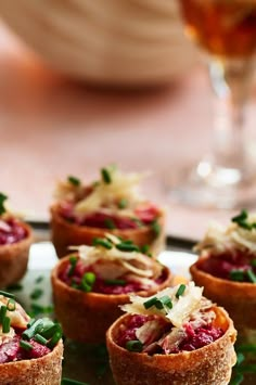 small appetizers are arranged on a plate with garnishes in them