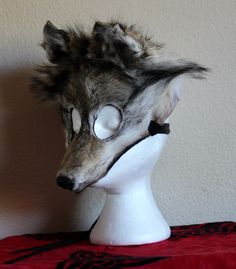 a white mannequin head with an animal's face on top of it