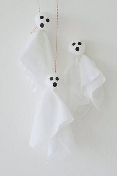 two white ghost decorations hanging from strings