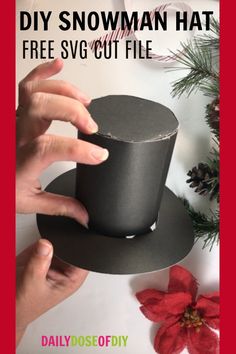 someone is holding a black paper hat with the words diy snowman hat free svg cut file