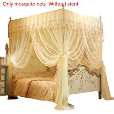 a canopy bed with sheer curtains on the top and bottom, sitting in a room