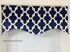 a blue and white window valance hanging over a window