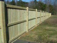 a wooden fence in the middle of a field