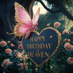 a pink butterfly sitting on top of a heart shaped sign with the words happy birthday heaven