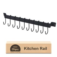 the kitchen rail is next to an empty box and it has hooks hanging from it