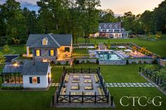 an aerial view of a house with a pool and hot tub in the yard at dusk