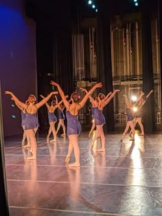 a group of young women dancing on top of a stage