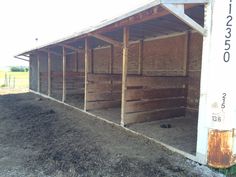 the inside of a horse barn that is being built with wooden slats on it