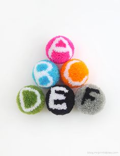 four colorful balls with the word abc's written in white and black on them