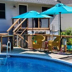 an above ground pool with chairs and umbrellas