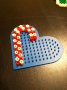 a heart shaped object made out of plastic beads