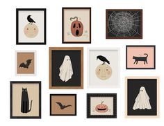 halloween art is displayed on the wall in various frames with bats, cats and pumpkins