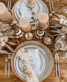 the table is set with silverware and place settings