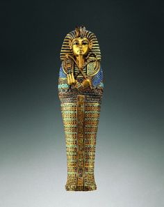 an egyptian statue is shown in gold and blue with intricate designs on it's body