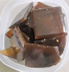 a white plate topped with pieces of chocolate