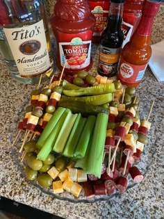 a platter filled with celery, pickles and ketchup on skewers