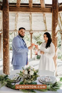 a man and woman standing next to each other at a table