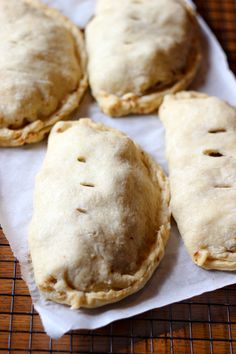 four pastries sitting on top of a piece of paper