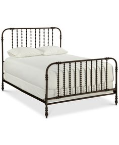 a metal bed frame with white sheets and pillows on top of it, against a white background