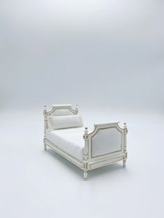 a white bed sitting on top of a white floor