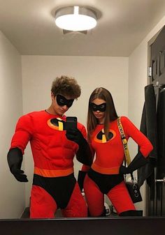 two people dressed as the incredibles are taking a selfie in front of a mirror