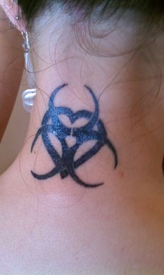 a woman's neck with a tattoo on it that has a biohazard symbol