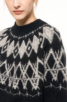 a woman wearing a black and white sweater