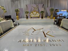 the dance floor is decorated with flowers and gold accents for an elegant wedding reception at amw & nammi may 21st, 2013