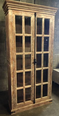 an old wooden cabinet with glass doors