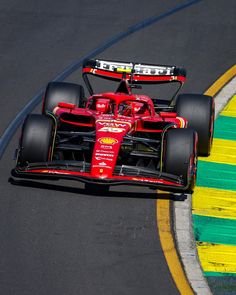 a red race car driving on a track