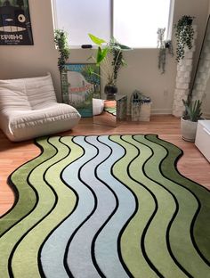 a living room area with a rug, chair and couch in it's corner