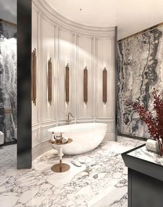 a bathroom with marble walls and flooring has a large bathtub in the center