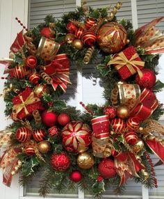 a christmas wreath with red and gold ornaments