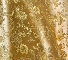 gold and white fabric with floral designs on it