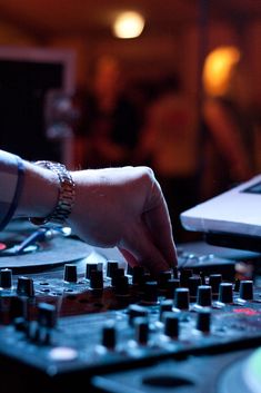 a dj mixing music in front of a laptop