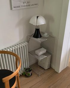 a lamp sitting on top of a metal shelf next to a radiator