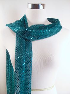 "IMPORTANT - Read all \"ITEM DETAILS\" before ordering. Sequin Scarf- Teal Sequin Party Scarf - Teal Sequin Scarf - Shiny Teal Sequin Scarf - Long Sequin Party Scarf ** Choice of squared or tapered ends. ** Great accent for that holiday party dress. Makes a great gift, too! Light weight sequined knit fabric. Small teal sequins on a lightweight teal knit fabric. Professionally finished, edges are serged with a decorative three thread hem. DIMENSIONS: Approximately 76 inches in length. Approximate Sparkly Scarf, Sequin Scarf, Holiday Party Dress, Sequin Party, Wedding Sash, Holiday Party Dresses, Scarf Gift, Olive Color, Green Satin