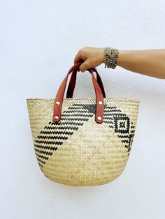 Looking for a summery way to tote your beach essentials? These handmade basket bags from Oaxaca are the perfect choice! Each bag is handcrafted with care and attention to detail by skilled artisans using traditional techniques. These all-natural baskets are made from palm leaves, and and dyed with beautiful traditional designs. Since each basket is handmade, no two are exactly alike, so you can be sure that the one you choose is truly unique. The addition of genuine leather straps adds durabilit Basket Bags, Natural Baskets, Diamond Weave, Handmade Baskets, Beach Essentials, Basket Bag, Palm Leaves, Traditional Techniques, Leather Handle