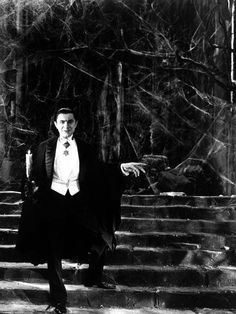 a man in a suit and tie standing on some steps with his arms out to the side