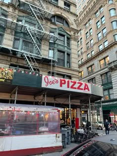 a pizza restaurant in the middle of a city