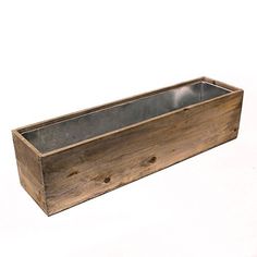 a wooden planter with metal inserts on the bottom is shown in front of a white background