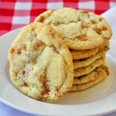 a white plate topped with cookies on top of a red and white checkered table cloth