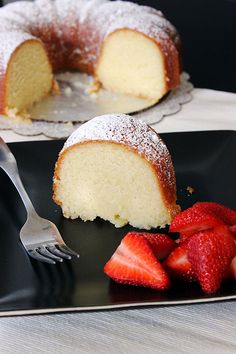 a piece of cake and some strawberries on a plate