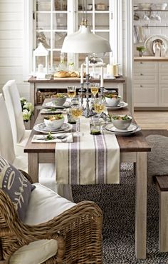 a dining room table is set with plates and glasses