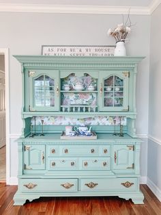 an old china cabinet painted in aqua and gold