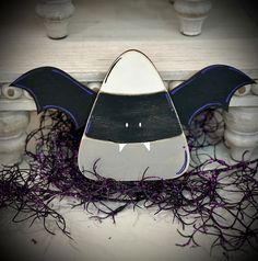 a wooden bat decoration sitting on top of a table