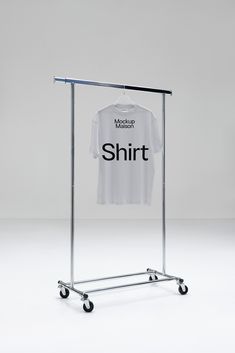 a t - shirt is hanging on a rolling rack